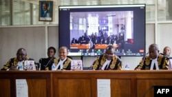 Uganda's deputy chief justice and head of the court Buteera (2nd R), with other five judges, delivers a judgment on the consolidated petitions challenging the constitutionality of the Anti-Homosexuality Act in Kampala, April 3, 2024. 