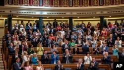 Spain's Prime Minister Pedro Sanchez, foreground left, applauds after the approval to an amnesty law at the Spanish parliament's lower house in Madrid, May 30, 2024. 