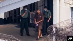 FILE - Jimmy Lai walks through the Stanley prison in Hong Kong, July 28, 2023. Journalists say Hong Kong's national security law has led to media shutdowns and the loss of hundreds of media jobs.