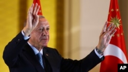 Turkish President and People's Alliance's presidential candidate Recep Tayyip Erdogan gestures to supporters at the presidential palace, in Ankara, Turkey, May 28, 2023.