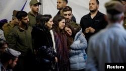 Mourners react during the funeral of Israeli military commander Lieutenant Colonel Tomer Grinberg, who was killed in northern Gaza, at Mount Herzl military cemetery in Jerusalem, Dec. 13, 2023. 