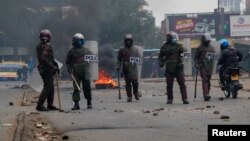 Riot police members operate during an anti-government demonstration following nationwide deadly riots over tax hikes and a controversial now-withdrawn finance bill, in Nairobi, July 16, 2024. 