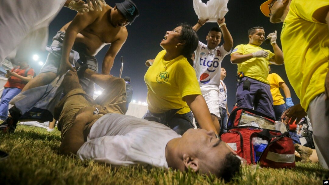 Rescuers attend an injured fan lying on the field of the Cuscatlan stadium in San Salvador, El Salvador, May 20, 2023. 