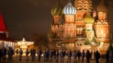 FILE - Police and the Rosguardia (National Guard) servicemen walk in Red Square, closed for celebrations on New Year's Eve, with the St. Basil's Cathedral, in Moscow, Dec. 31, 2022. 