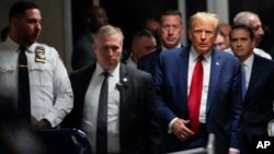 FILE - Former President Donald Trump leaves Manhattan criminal court, Feb. 15, 2024, in New York. Prosecutors said March 14 that they were open to delaying the start of Trump’s hush money trial to give his lawyers time to review new evidence.