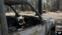 A vehicle is seen scorched by the Park Fire in the Cohasset community of Butte County, Calif., July 29, 2024. Firefighters made some progress over the weekend in the battle against wildfires in the western U.S. 