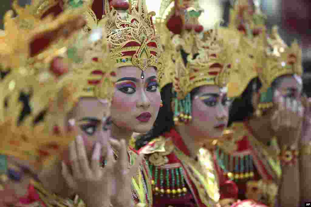 Female dancers line up before they perform during the opening of Bali Arts Festival in Bali, Indonesia.