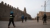 FILE - Police officers of the United Nations Stabilization Mission in Mali (MINUSMA) secure access to the Great Mosque in Timbuktu, on Dec. 9, 2021.