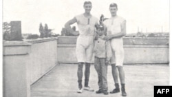 This undated photograph from 1900, shows Dutch rowers Francois Antoine Brandt and Roelof Klein as they pose with their 'unknown' coxswain after he steered them to victory in the coxed pairs rowing event of the 1900 Paris Olympics in Paris.