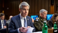 FBI director Christopher Wray looks through his notes before a Senate Intelligence Committee hearing to examine worldwide threats on Capitol Hill in Washington, March 8, 2023. 