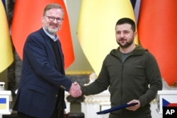 FILE - Czech Republic's Prime Minister Petr Fiala, left, and Ukrainian President Volodymyr Zelenskyy shake hands during their meeting in Kyiv, Ukraine, Oct. 31, 2022.