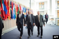 (L-R) Gaston Browne, prime minister of Antigua and Barbuda, Arnold Loughman, attorney-general of Vanuatu, and Kausea Natano, prime minister of Tuvalu, arrive for a hearing at the International Tribunal for the Law of the Seas, Sept. 11, 2023 in Hamburg, northern Germany.
