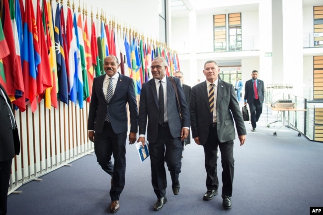 (L-R) Gaston Browne, prime minister of Antigua and Barbuda, Arnold Loughman, attorney-general of Vanuatu, and Kausea Natano, prime minister of Tuvalu, arrive for a hearing at the International Tribunal for the Law of the Seas, Sept. 11, 2023 in Hamburg, northern Germany.