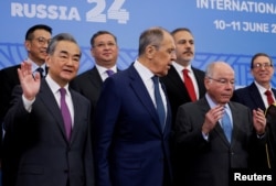 FILE - China's Foreign Minister Wang Yi, Russia's Foreign Minister Sergei Lavrov (C) and Brazil's Foreign Minister Mauro Vieira pose for a group photo during a meeting of the BRICS Plus Ministerial Council in Nizhny Novgorod, Russia, June 11, 2024.