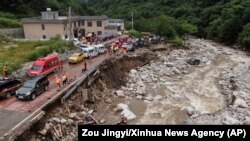 In this photo released by Xinhua News Agency, an aerial photo shows the aftermath of a mudslide in Weiziping village of Luanzhen township on the outskirts of Chang'an district, Xi'an of northwestern China's Shaanxi Province, Aug. 12, 2023.