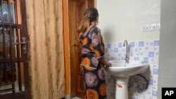 FILE - Anifa stands in her home in the eastern Congo town of Goma, Democratic Republic of the Congo, March 5, 2021. 