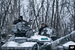 A Ukrainian tank rides to its position in the frontline in Bakhmut, Donetsk region, Ukraine, Feb. 12, 2023.