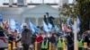 FILE - People protest for an extension and expansion of the Temporary Protected Status (TPS) program, Friday, Sept. 23, 2022, at Lafayette Park by the White House in Washington.