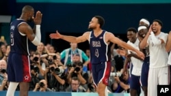 United States' Stephen Curry (4) and LeBron James (6) celebrate after beating France to win the gold medal during a men's gold medal basketball game at Bercy Arena, Aug. 10, 2024, in Paris.