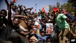 FILE - People rally in Ouagadougou, Burkina Faso, on Jan. 25, 2022, in support of the military junta that seized control of the country. Juntas in Mali, Burkina Faso and Niger agreed to create a joint force to fight extremist violence in their nations.