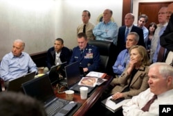 FILE - In this May 1, 2011 file image released by the White House and digitally altered by the source to diffuse the paper in front of Secretary of State Hillary Clinton, President Barack Obama and Vice President Joe Biden, along with members of the national security team, receive an update on the mission against Osama bin Laden in the Situation Room of the White House in Washington.