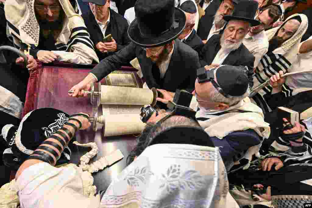 Hasidic Jewish pilgrims pray with the Torah in the former house of late miracle rabbi Yeshaya Steiner, also known as Rebbe Shaya&#39;le, in the village of Bodrogkeresztur, Hungary, April 24, 2023, during a pilgrimage of Hasidic Jews on the occasion of Rabbi Steiner&#39;s 98th death anniversary.