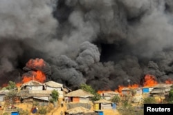 FILE - Fire burns in the Rohingya refugee camp in Balukhali in Cox's Bazar, Bangladesh, March 5, 2023.