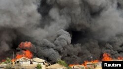 Fire burns in the Rohingya refugee camp in Balukhali in Cox&#39;s Bazar, Bangladesh.