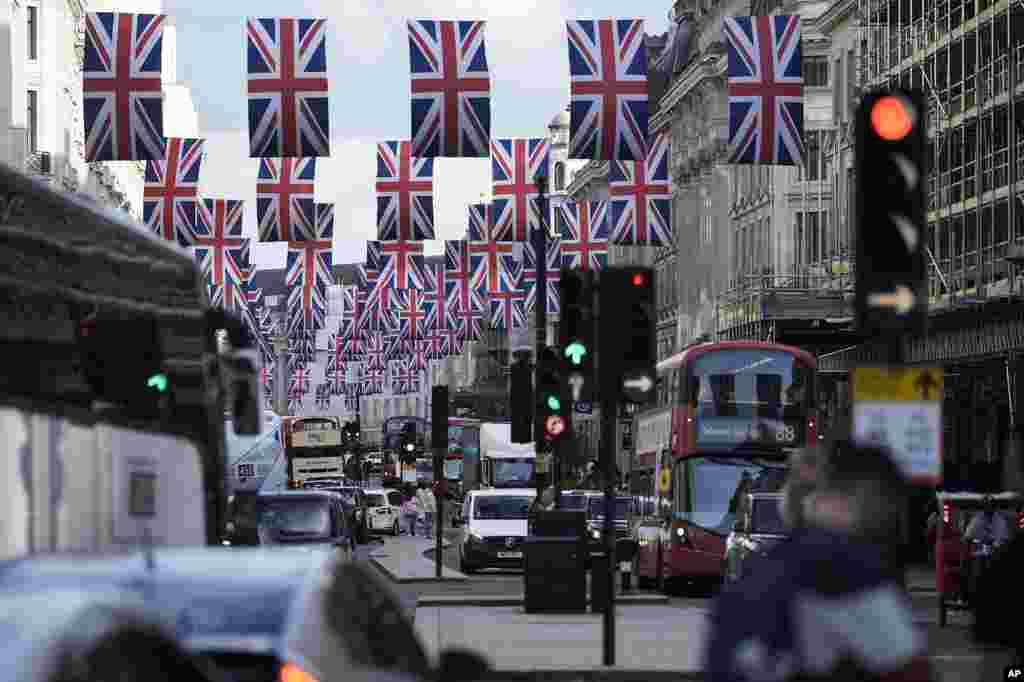Traffic moves through the decorated Regent Street in central London, May 5, 2023.