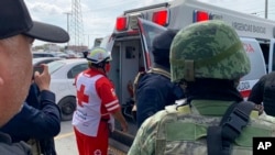 A Red Cross worker closes the door of an ambulance carrying two Americans found alive after their abduction in Mexico last week, in Matamoros, March 7, 2023. 
