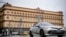 FILE - A police car goes past the headquarters of the Federal Security Service in central Moscow on March 3, 2023. Two Ukrainian journalists were detained by the Russian Federal Security Service in August 2023. Their whereabouts are unknown.