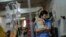 A man comforts his child suffering from dengue at Mugda Medical College and Hospital in Dhaka, Bangladesh, Sept. 14, 2023. 