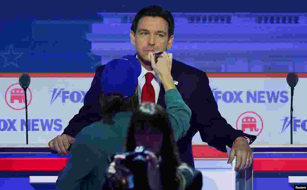 Republican presidential candidate Florida Governor Ron DeSantis gets his makeup touched up during a commercial break at the first Republican candidates' debate of the 2024 U.S. presidential campaign in Milwaukee, Wisconsin.