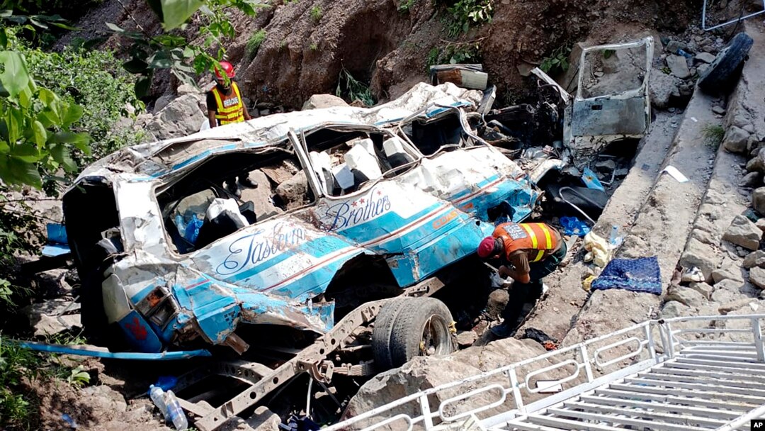 Rescue workers look for the victims and wounded passengers from the wreckage of a bus that fell into a ravine, near Kahuta, Pakistan, Aug. 25, 2024. 