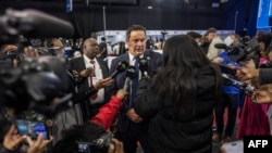 FILE: Leader of the Democratic Alliance (DA), South African main opposition party, John Steenhuisen, center, speaks with the media at the Independent Electoral Commission National Results Center in Midrand, May 31, 2024.