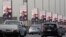 Vehicles pass near banners supporting Egyptian President Abdel-Fattah el-Sissi for the presidential elections, in Cairo, Egypt, Dec. 10, 2023.