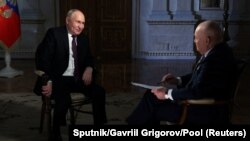 Russian President Vladimir Putin speaks with Director General of Rossiya Segodnya media group Dmitry Kiselyov during an interview in Moscow, March 12, 2024. 