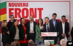 Communist Party national secretary Fabien Roussel, third from right, speaks during a media conference surrounded by leaders of France's left-wing coalition for the upcoming election in Paris, June 14, 2024.