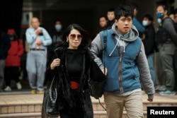 Jimmy Lai's wife and son Lai Shun Yan leave the West Kowloon Magistrates' Courts during the break of the national security trial of media mogul Jimmy Lai, founder of Apple Daily, in Hong Kong, China, Dec. 18, 2023.