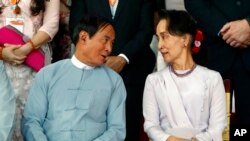 FILE - Win Myint, left, since ousted as Myanmar's president, speaks to Aung San Suu Kyi after the fourth anniversary of Nationwide Cease-fire Agreement at the Myanmar International Convention Center in Naypyitaw, Myanmar, Oct. 28, 2019.