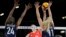 Li Yingying of China spikes the ball as Chiaka Ogbogu and Andrea Drews of the United States try to block her during the group A women's volleyball match between the United States and China at the 2024 Summer Olympics, July 29, 2024, in Paris.