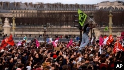 Protesters gather at Concorde square near the National Assembly in Paris, March 16, 2023, rallying against a move by French President Emmanuel Macron to raise the country's retirement age from 62 to 64 without a vote by lawmakers.