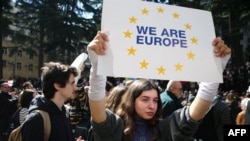 Georgian protesters rally outside parliament as lawmakers vote to call off a controversial 'foreign agent' bill in Tbilisi, March 10, 2023.