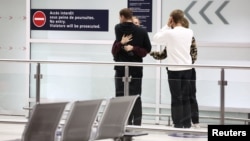 French nationals and other European citizens who evacuated Niger after a junta seized power in the West African country, arrive at the Paris Charles de Gaulle Airport in Roissy, near Paris, Aug. 2, 2023.