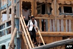 Tourists visit a traditional wooden ships, called lenjes, on Iran's touristic Qeshm island in the Gulf, on April 29, 2023.