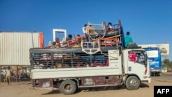 Displaced people fleeing from Wad Madani in Sudan's Jazira state arrive in Gedaref in the country's east, Dec. 19, 2023. 