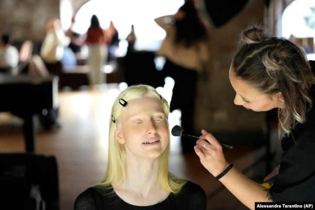 Lucia Della Ratta gets makeup during a photo shoot for "L'Imperfetta (The Imperfect) model agency" in Rome, Tuesday, Feb. 7, 2023.