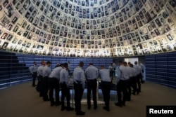 Visitors tour an exhibition, ahead of Israel's national Holocaust memorial day at Yad Vashem, the World Holocaust Remembrance Center, in Jerusalem, May 5, 2024.