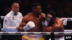 British boxer Anthony Joshua (R) competes with Cameroonian-French boxer Francis Ngannou during their heavyweight boxing match in Riyadh's Kingdom Arena indoor stadium, on March 9, 2024.