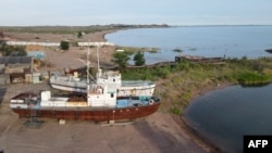 Rusted vessels rest on the shore of Lake Balkhash in Kazakhstan on June 18, 2024.